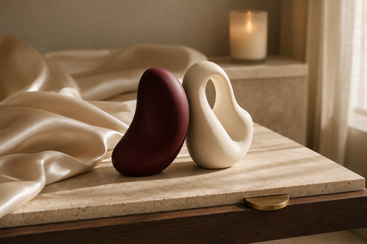Burgundy and ivory sculptural forms on travertine with champagne silk